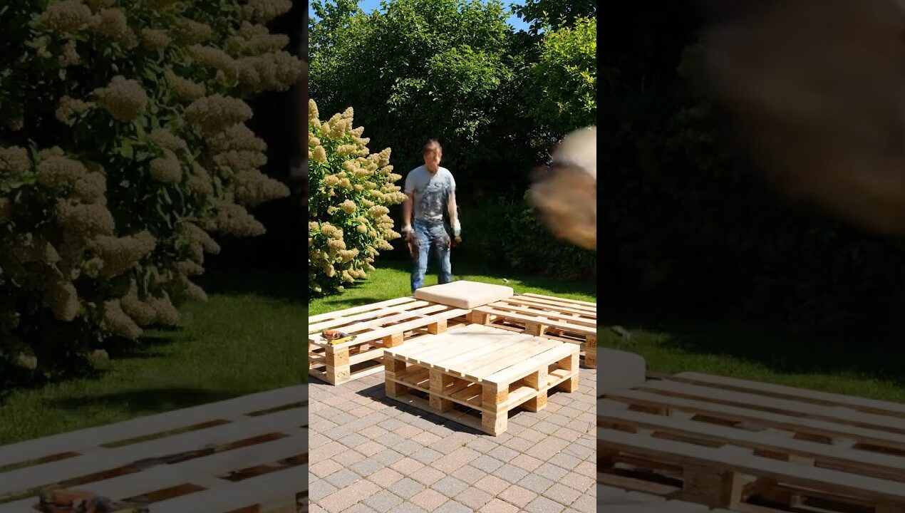 Outdoor sectional pallet sofa set a rustic design with beige cushions and a matching pallet table.